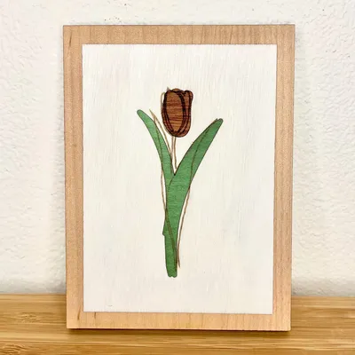 A multi-layer tulip art piece made from colored wood veneers.