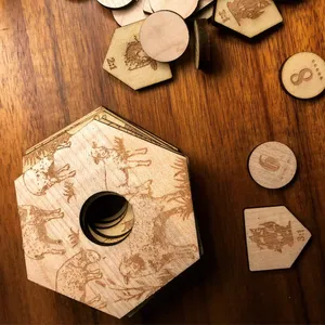 A stack of engraved Catan hexes and other pieces.