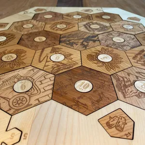 Engraved Catan base game pieces made out of solid wood featuring maple wood surround.