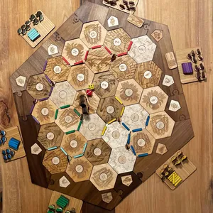 Engraved Catan extension pieces with walnut surround and multi-color player pieces.