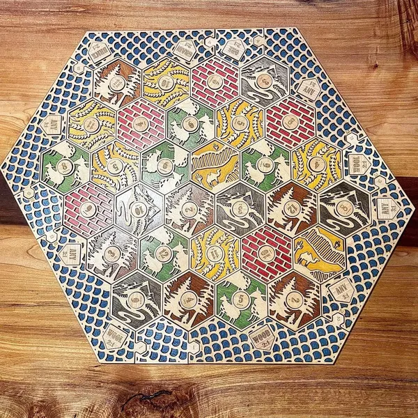 A two-layer Catan board with engraved hexes.