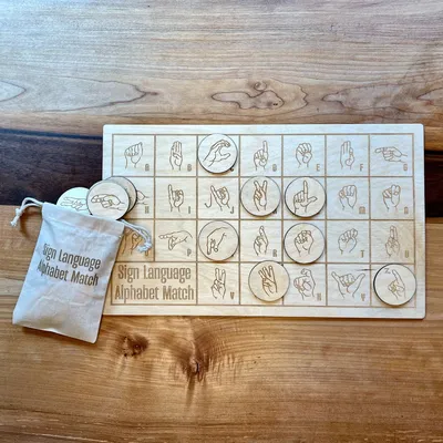 ASL letter matching game with engraved tokens for each letter.