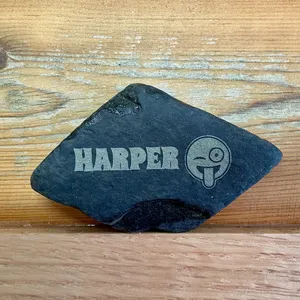 A rock that has been personalized with a laser engraved name on it.